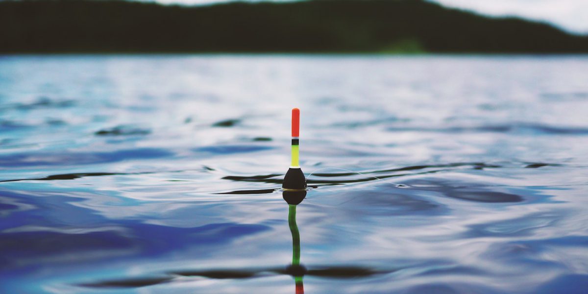 Red yellow and black bouy on body of water during daytime 190294